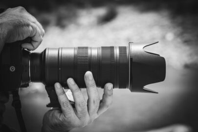 Hands holding a digital SLR camera with zoom digital lens - slon.pics - free stock photos and illustrations