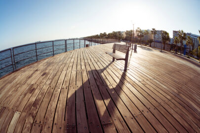 Lonely empty bench at seaside pier. Mediterranean sea coast - slon.pics - free stock photos and illustrations