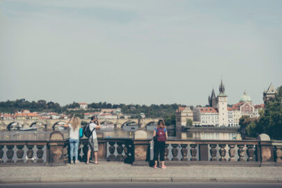 Travelers with backpacks taking photos of Prague at Legion Bridge (Most Legii) - slon.pics - free stock photos and illustrations