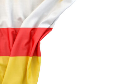 Flag of South Ossetia in the corner on white background. Isolated, contains clipping path - slon.pics - free stock photos and illustrations