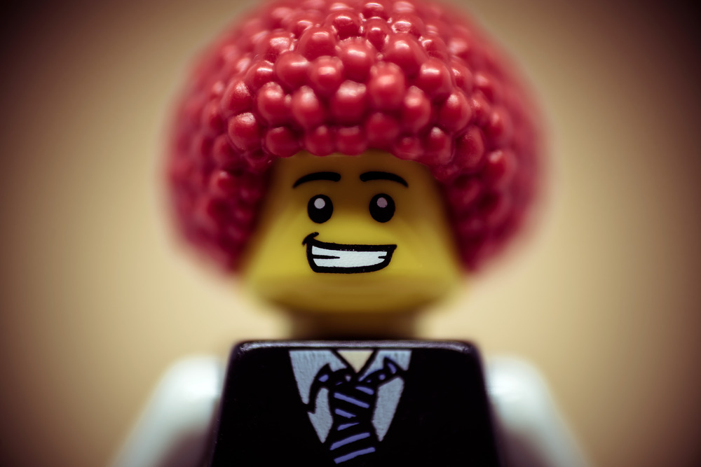 Portrait of a happy smiling businessman with clown wig