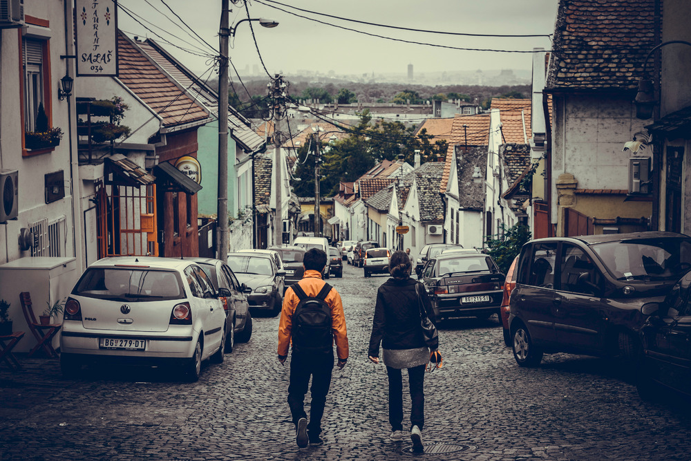 Traveling couple walking through old town of Zemun. Republic of Serbia