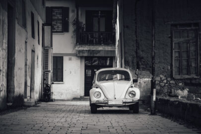 Old car parked in front of house wall - slon.pics - free stock photos and illustrations