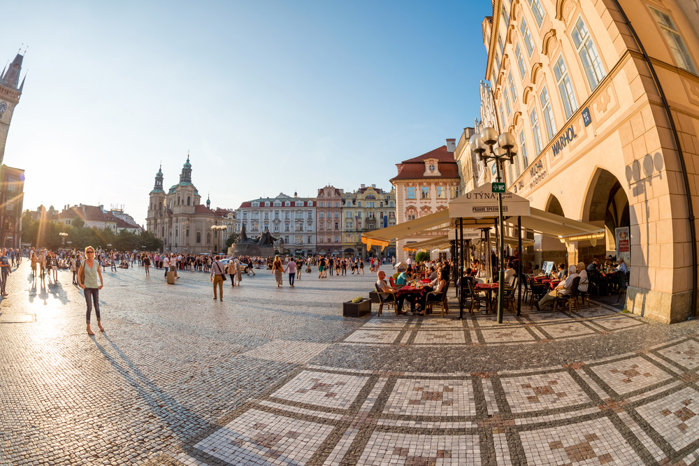 People resting in street cafes at Old town square. Prague, Czech Republic