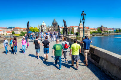 Tourists walking along the Charles Bridge while sightseeing in Prague. Czech Republic - slon.pics - free stock photos and illustrations