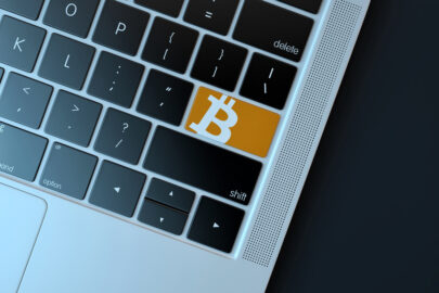 Bitcoin icon on laptop keyboard. Technology concept - slon.pics - free stock photos and illustrations