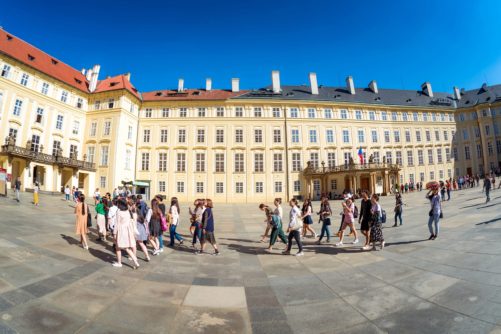 Group of tourists in the third courtyard of Prague Castle. Prague, Czech Republic, May 18, 2017