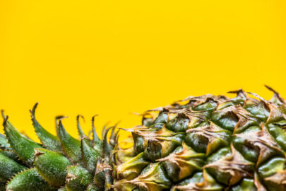 Lying pineapple on simple yellow background - slon.pics - free stock photos and illustrations