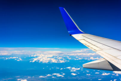 Wing of airplane flying above the clouds - slon.pics - free stock photos and illustrations