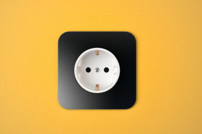 Black receptacle on yellow wall - slon.pics - free stock photos and illustrations