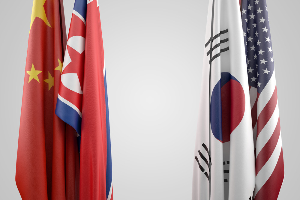 Flags of USA, China, South and North Korea. Political confrontation concept