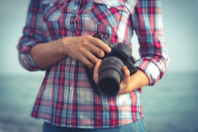DSLR camera held by woman - slon.pics - free stock photos and illustrations