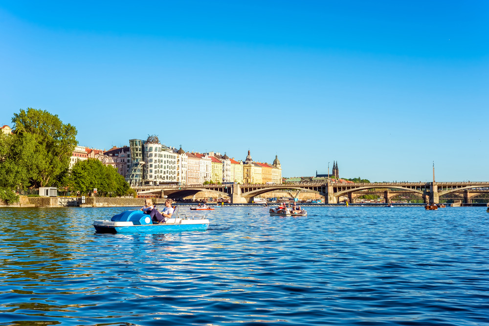 Tourists on pedal boat on the Vltava River. Prague, Czech Republic