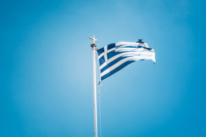 Greek flag waving against blue sky - slon.pics - free stock photos and illustrations
