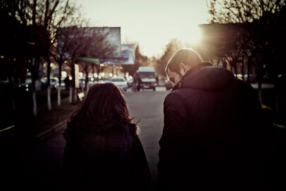 Rear view of young couple holding walking through the city street - slon.pics - free stock photos and illustrations