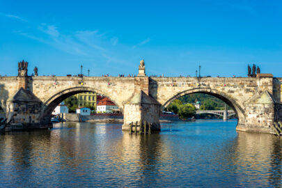 Charles Bridge over Vltava River against blue sky. Prague, Czech Republic - slon.pics - free stock photos and illustrations